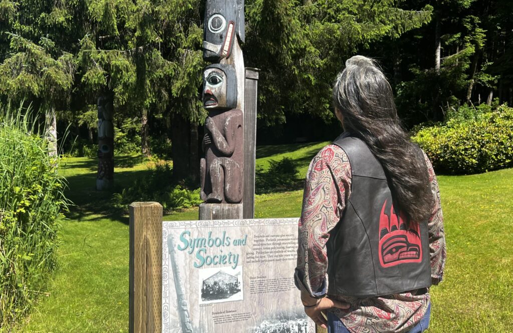 Kingsawin at looking at totem pole in Alaska - image